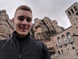 Montserrat, Catalonia, Spain - Selfie with Santa Maria de Montserrat Abbey in the background during my trip to Barcelona