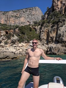 Pedra Longa, Sardinia, Italy - Me, posing with beautiful cliffs in the background while taking a boat ride
